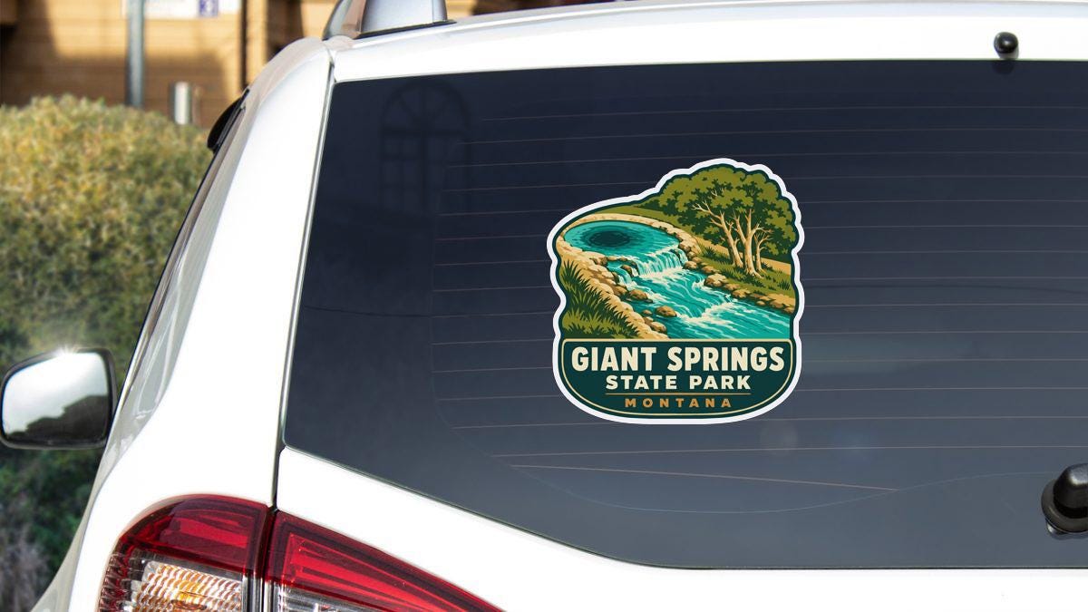 A sticker on the rear window of a white vehicle, depicting a scenic landscape with a river and waterfall.