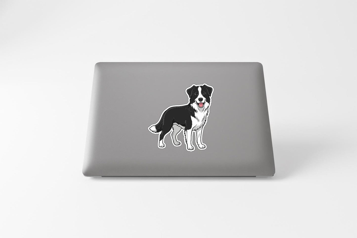 A sticker of a dog is on the back of a laptop.