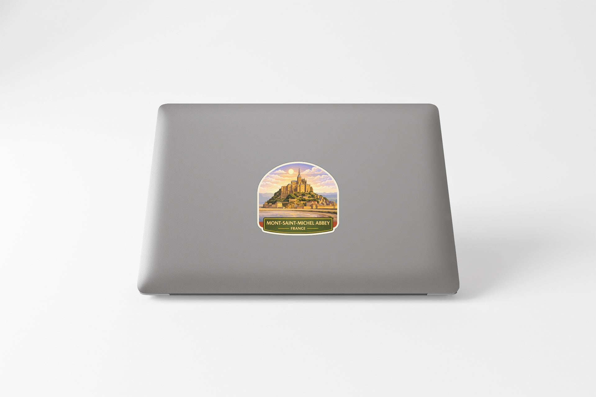 A sticker depicting a castle or palace on the back of a laptop computer.
