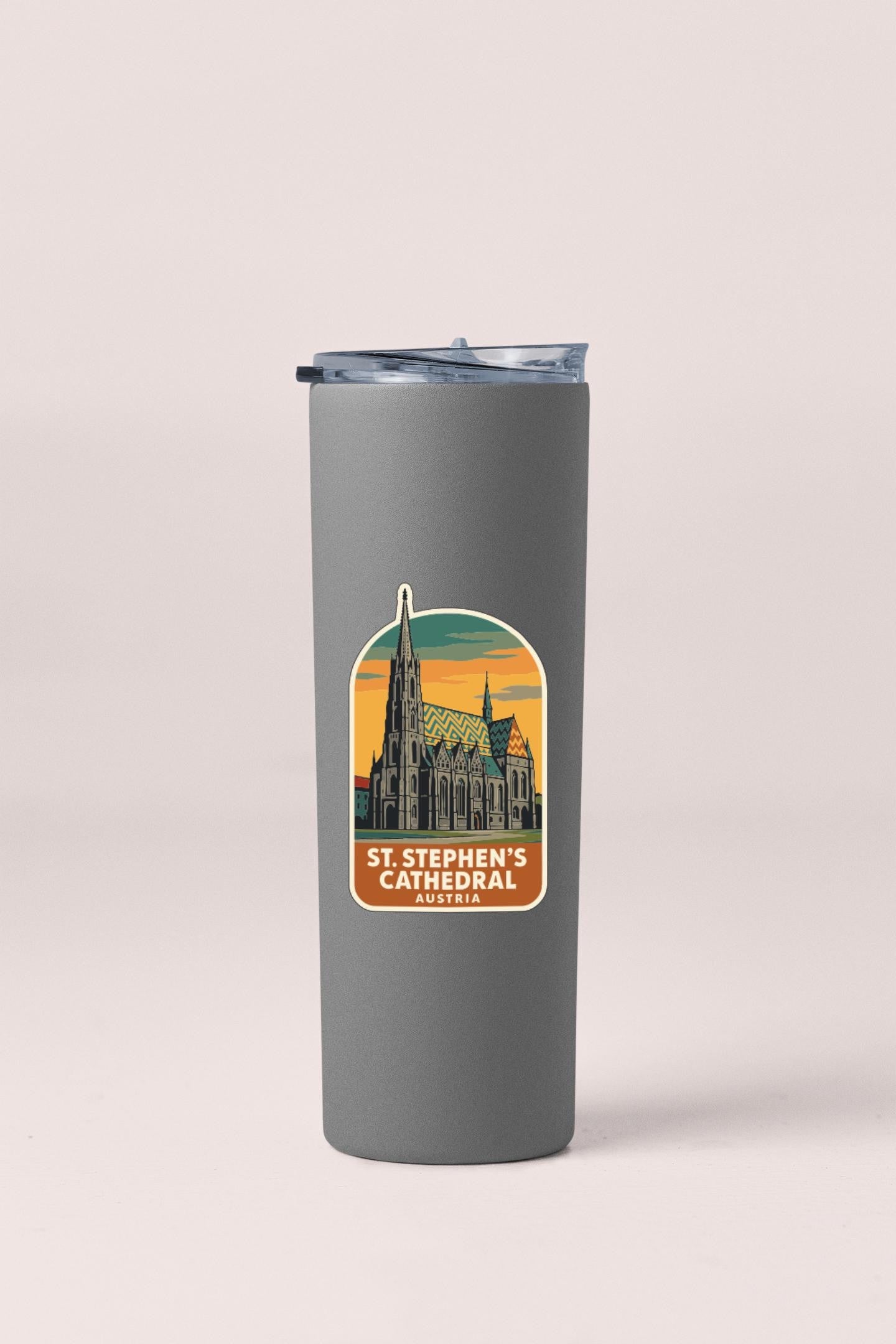 A gray insulated tumbler with a sticker depicting St. Stephen's Cathedral in Austria.