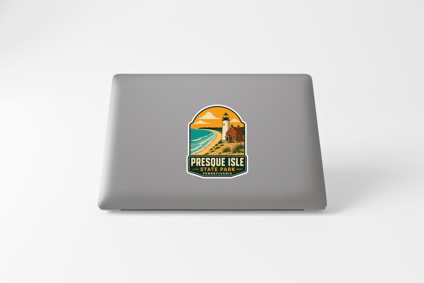 a sticker on the back of a laptop that displays a lighthouse and a beach scene, along with the text "PRESQUE ISLE PENNSYLVANIA".