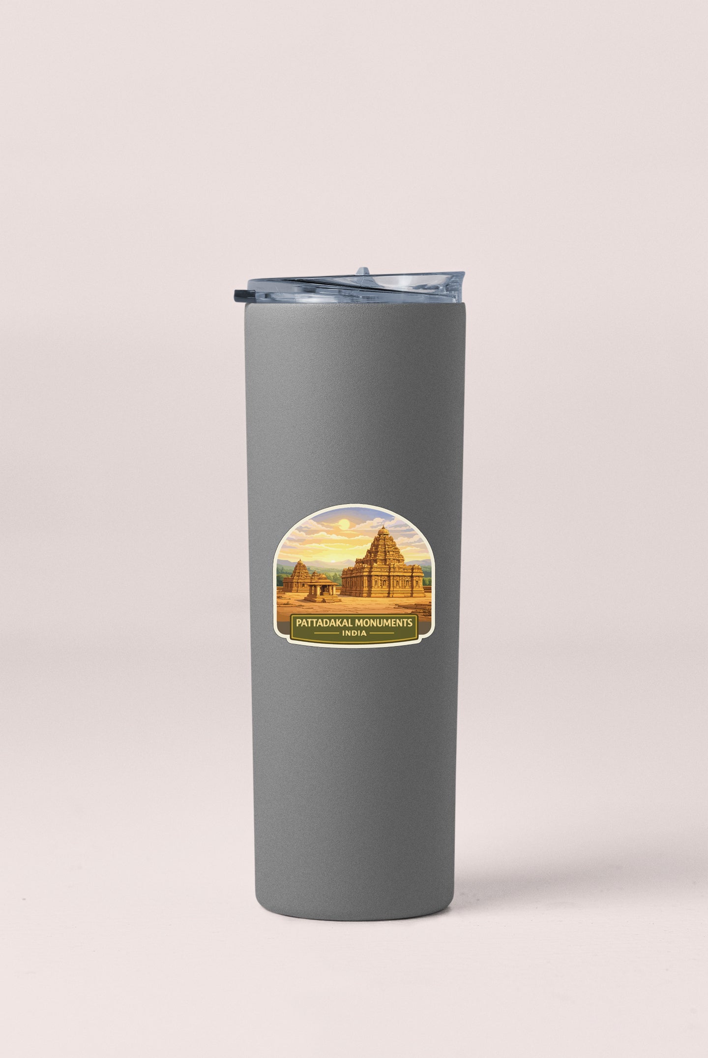 A gray tumbler with a sticker depicting a temple or monument.