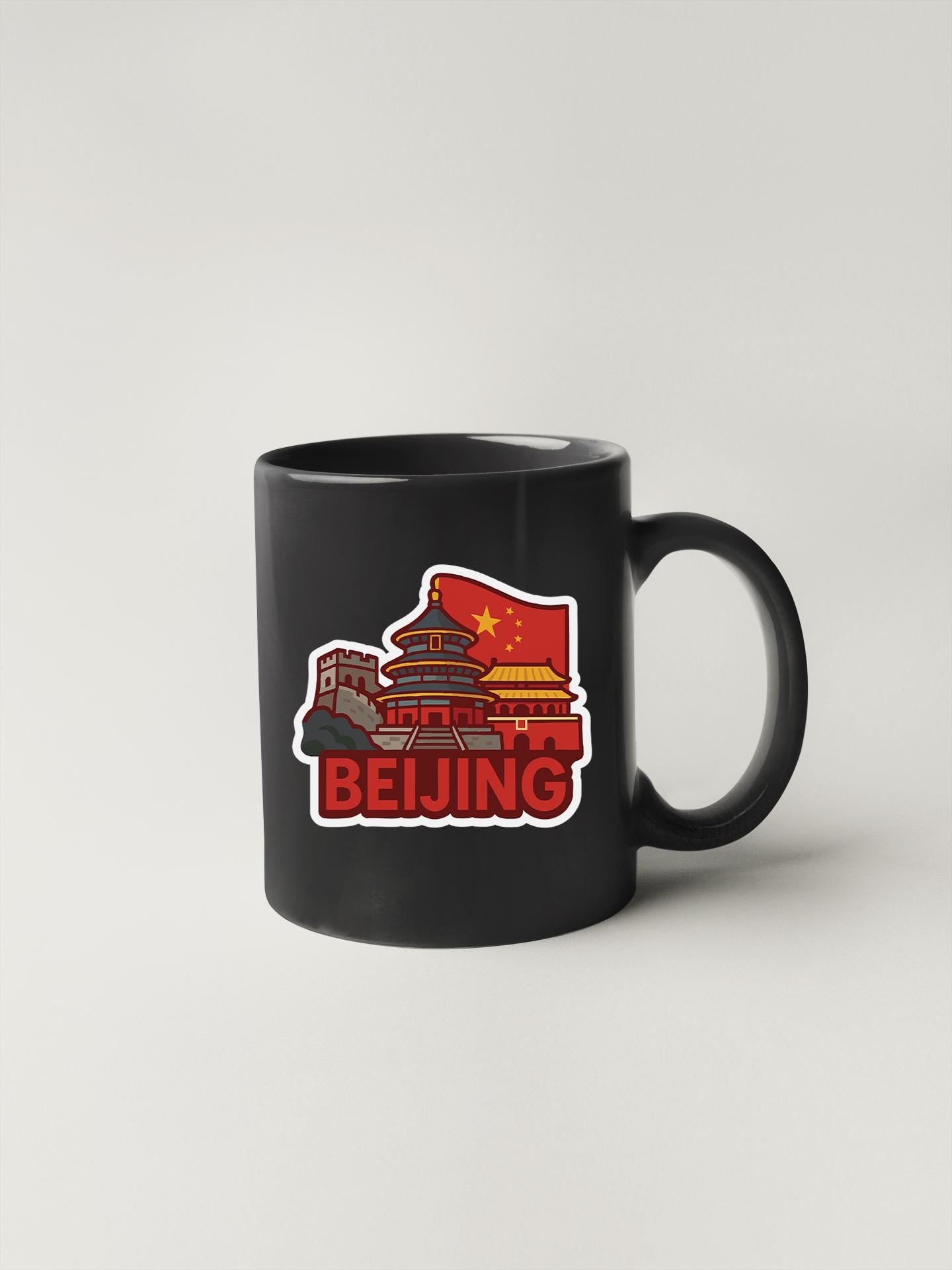 a black coffee mug with a red and yellow sticker on it