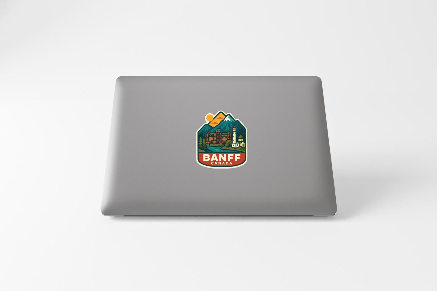 a sticker with a mountain and a city on a laptop.