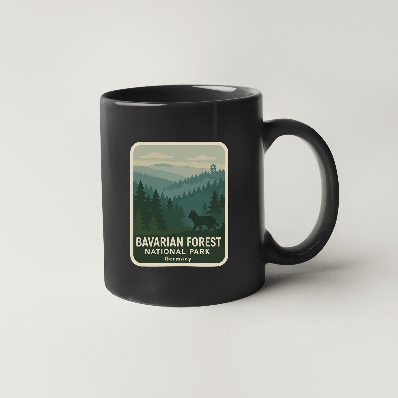 A black coffee mug with a label that says "BAVARIAN FOREST NATIONAL PARK GERMANY".