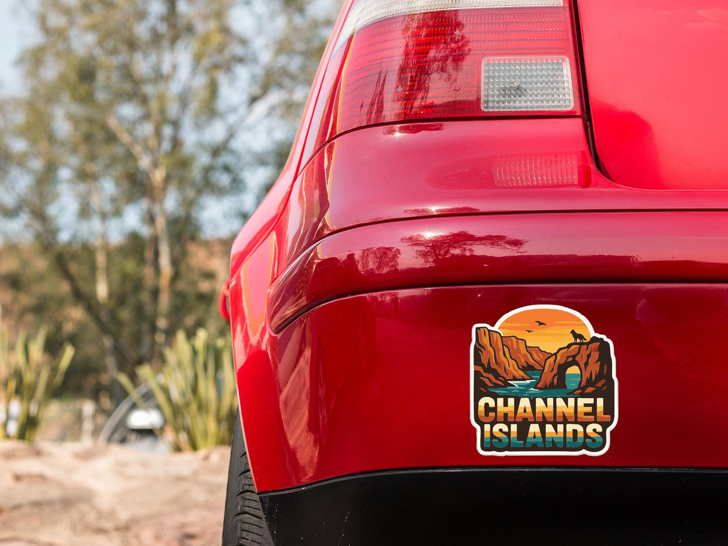 the rear end of a red car with a sticker on the trunk that says "Channel Islands".