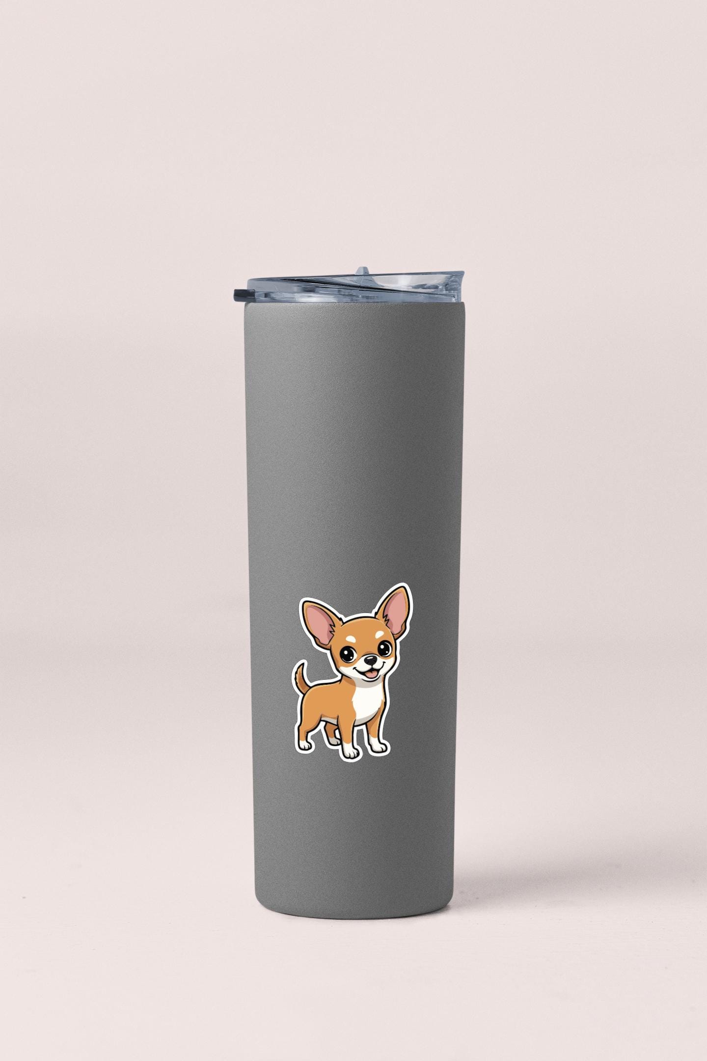 A gray insulated tumbler with a small cartoon dog sticker on it.