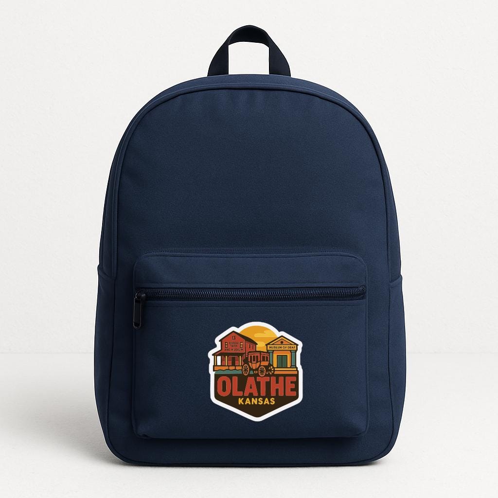 A navy blue backpack with a graphic of a house and the text "OLATHE KANSAS" printed on it.