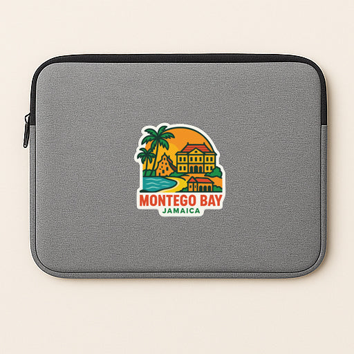 A gray laptop sleeve with a colorful sticker depicting a tropical island and buildings, representing Montego Bay, Jamaica.
