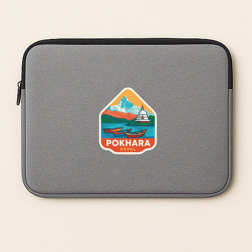 A gray laptop sleeve with a sticker depicting a scenic mountain landscape and a boat.