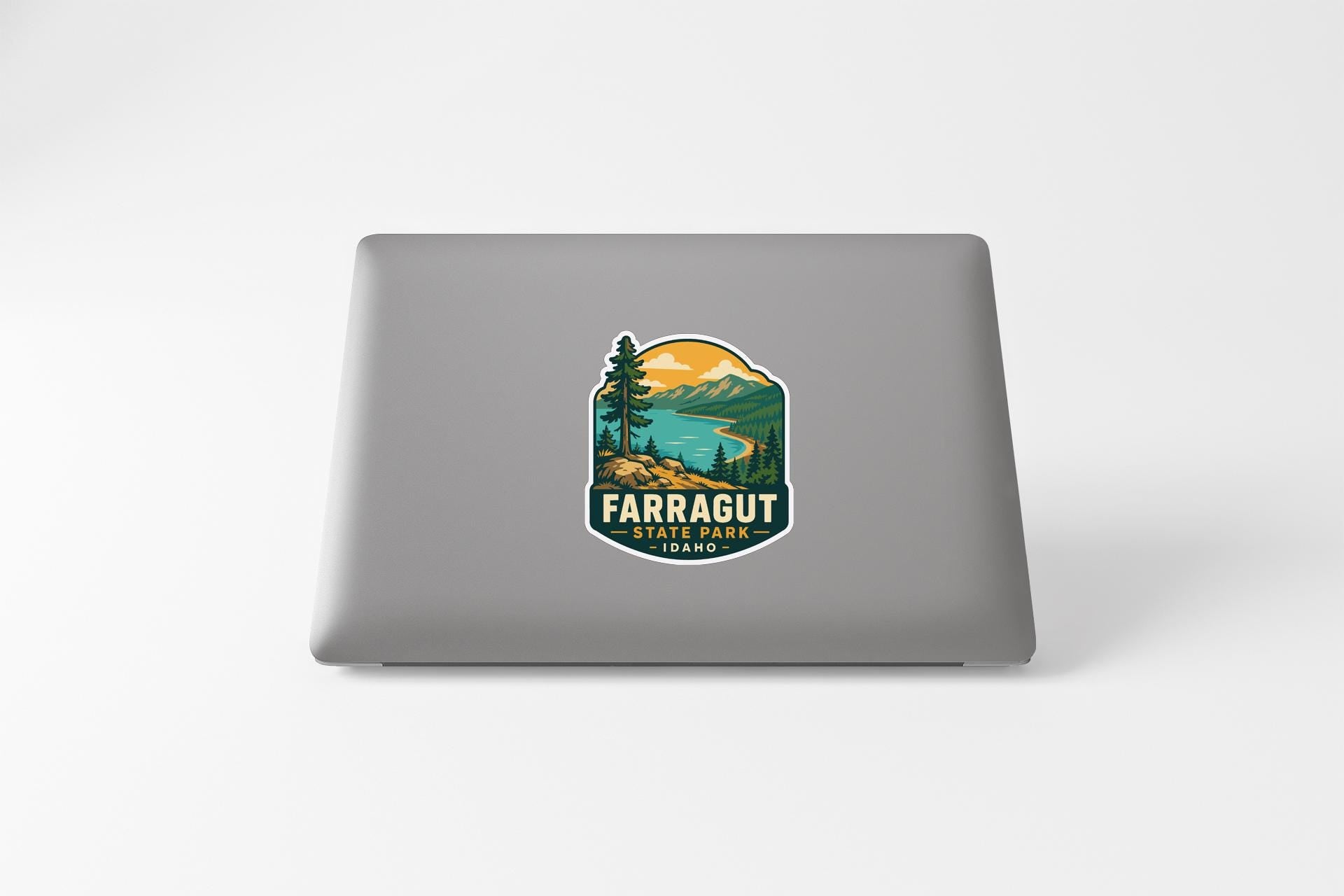 a sticker with a mountain landscape and a lake, with the text "Farragut" and "Park" printed on it.