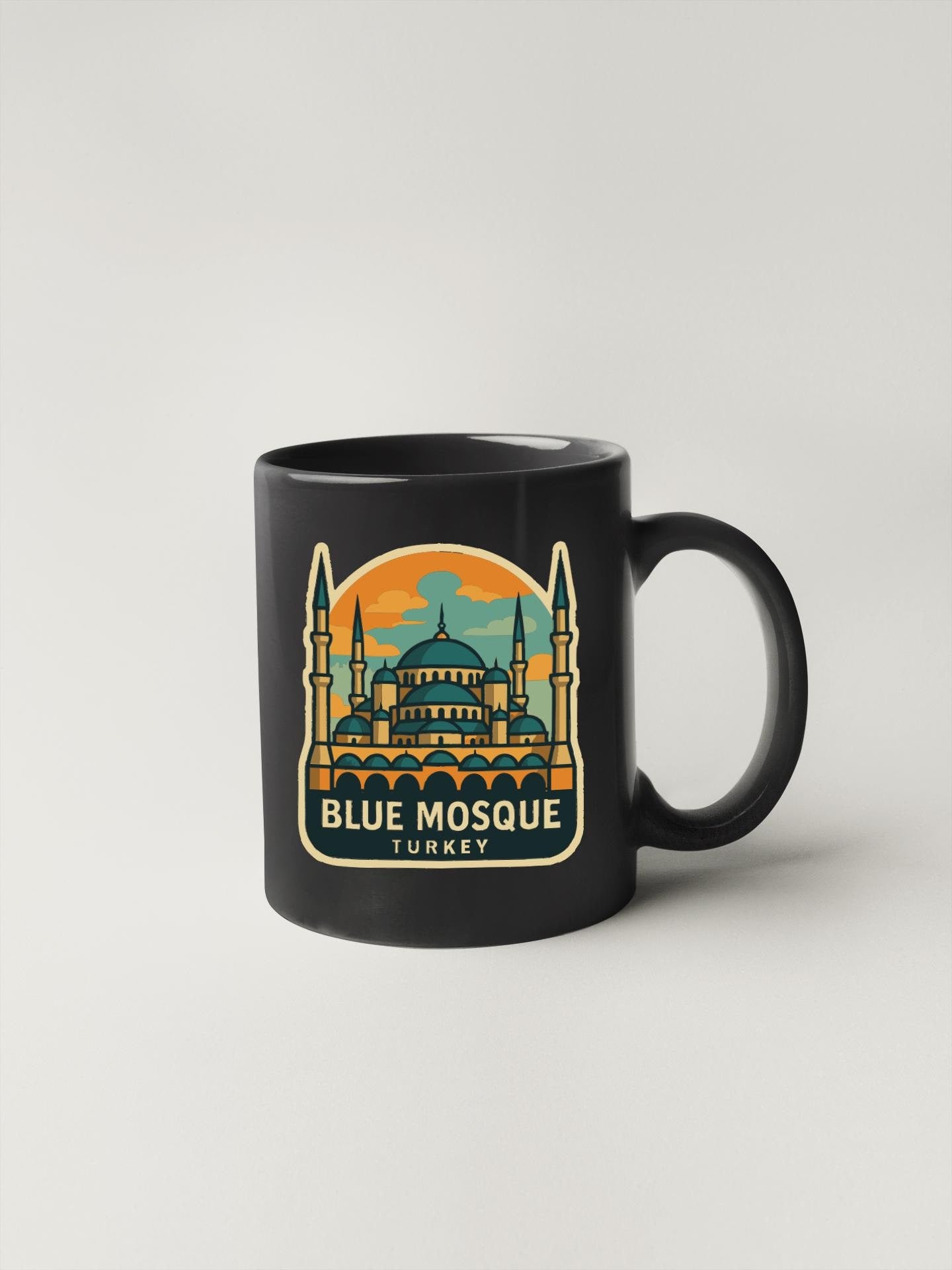 A black coffee mug with a graphic design depicting the Blue Mosque in Istanbul, Turkey.
