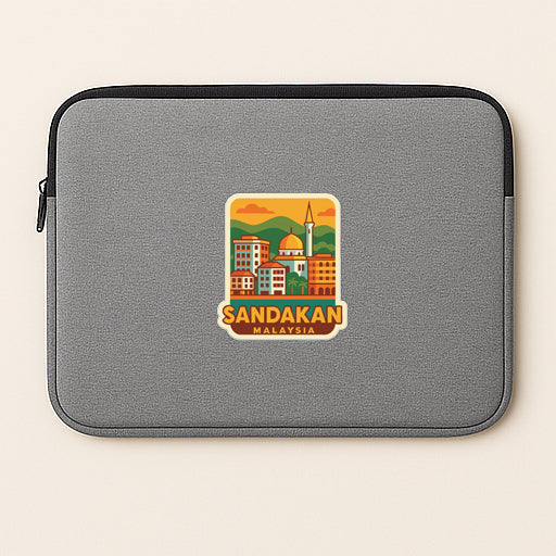 A gray laptop sleeve with a sticker of a cityscape and the text "Sandakan Malaysia" printed on it.