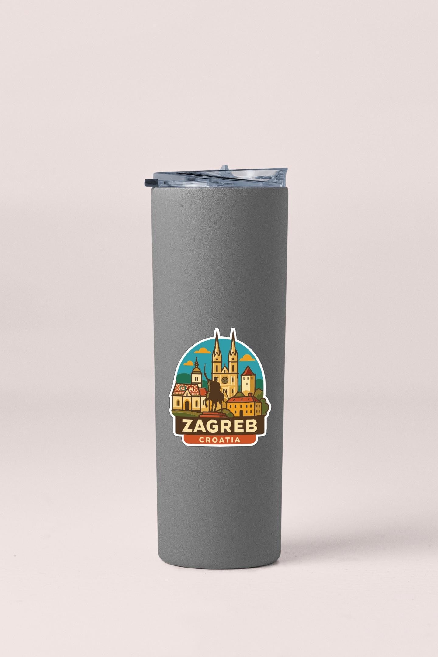 A gray insulated tumbler with a sticker depicting the cityscape of Zagreb, Croatia.