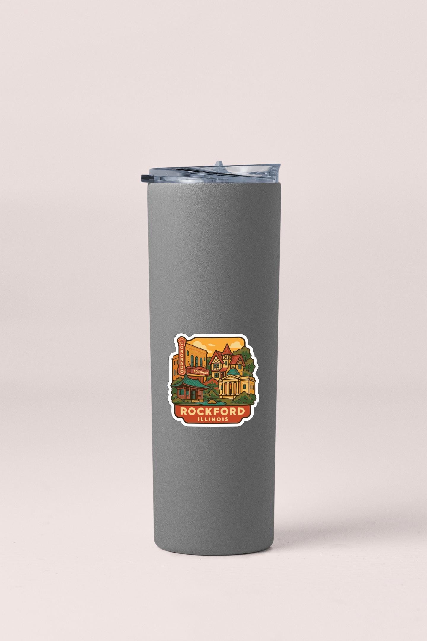 A gray insulated tumbler with a sticker depicting a colorful illustration of a building and the text "ROCKFORD, ILLINOIS".