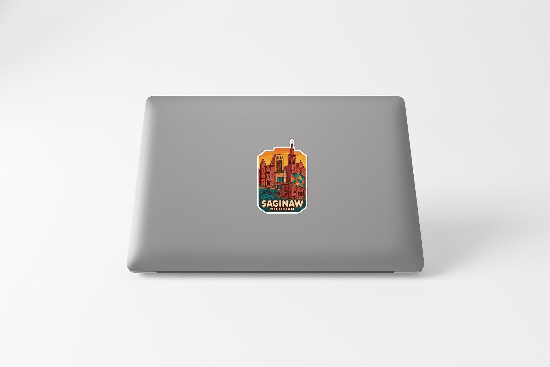 a sticker of a cityscape on the back of a laptop.