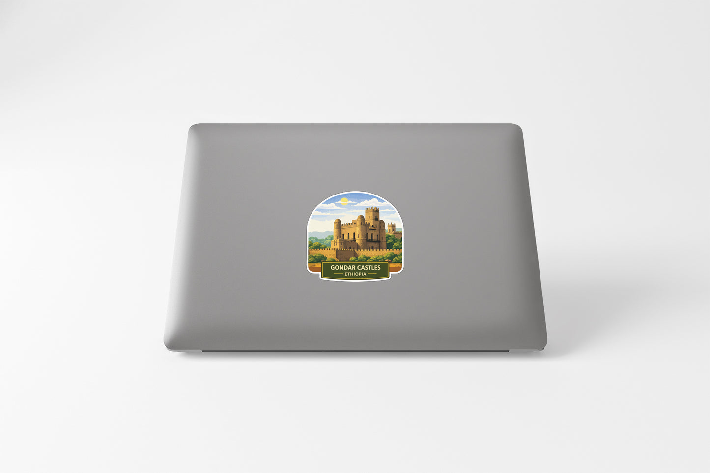 a sticker of a castle on the back of a laptop.