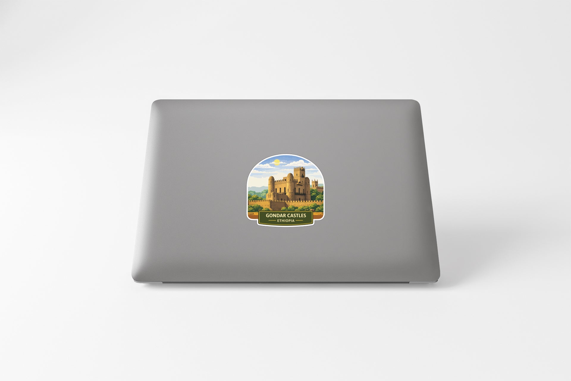 a sticker of a castle on the back of a laptop.