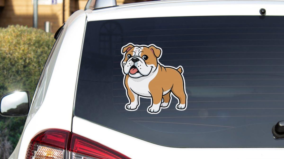 a cartoon illustration of a bulldog on the rear window of a car.