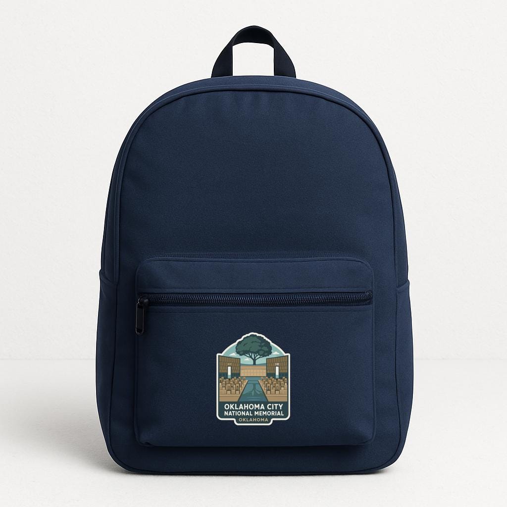 A navy blue backpack with a graphic on the front that says "OKLAHOMA CITY NATIONAL MEMORY".