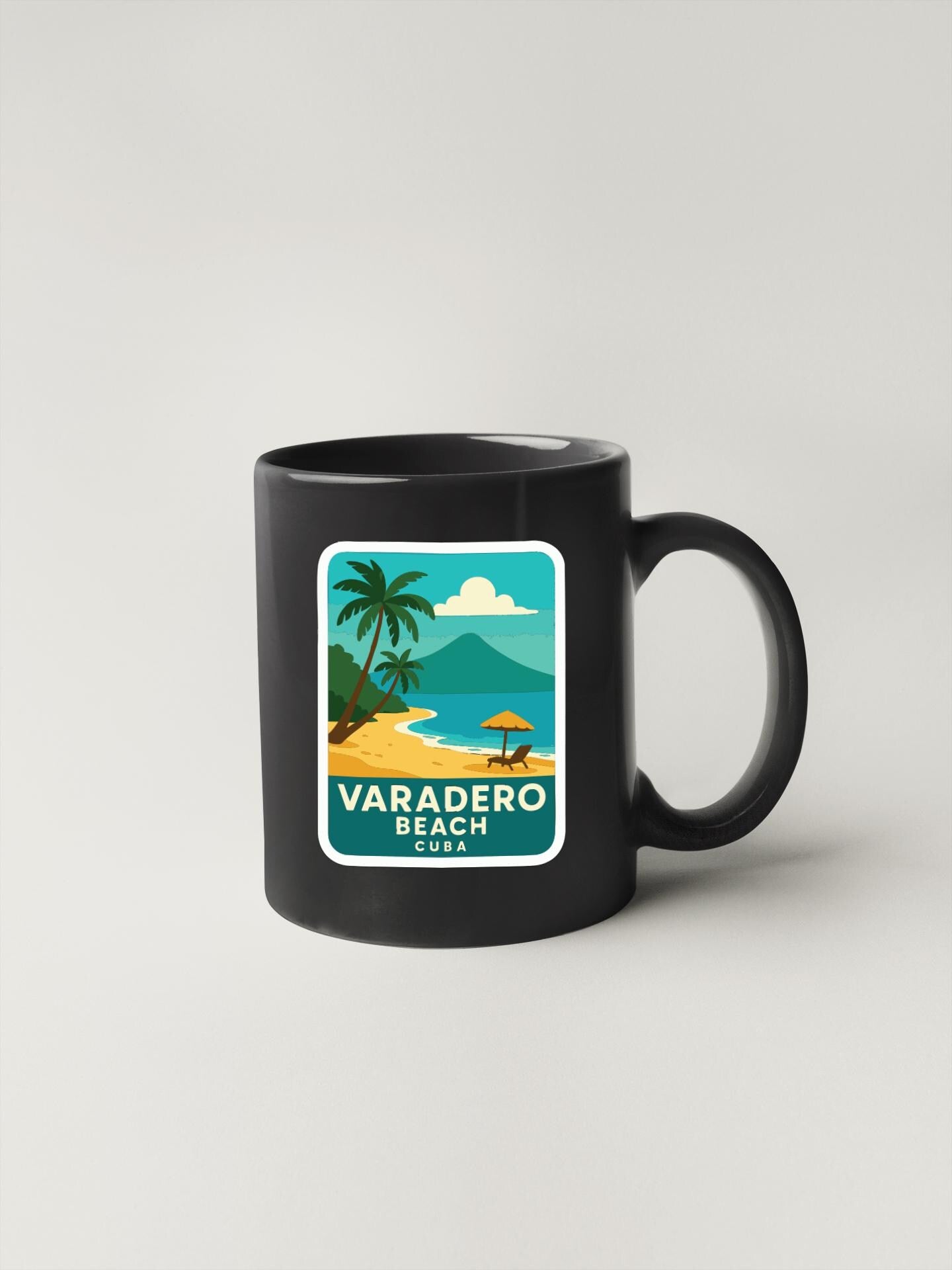 A black coffee mug with a tropical beach scene printed on it, featuring palm trees, a beach, and a mountain in the background.