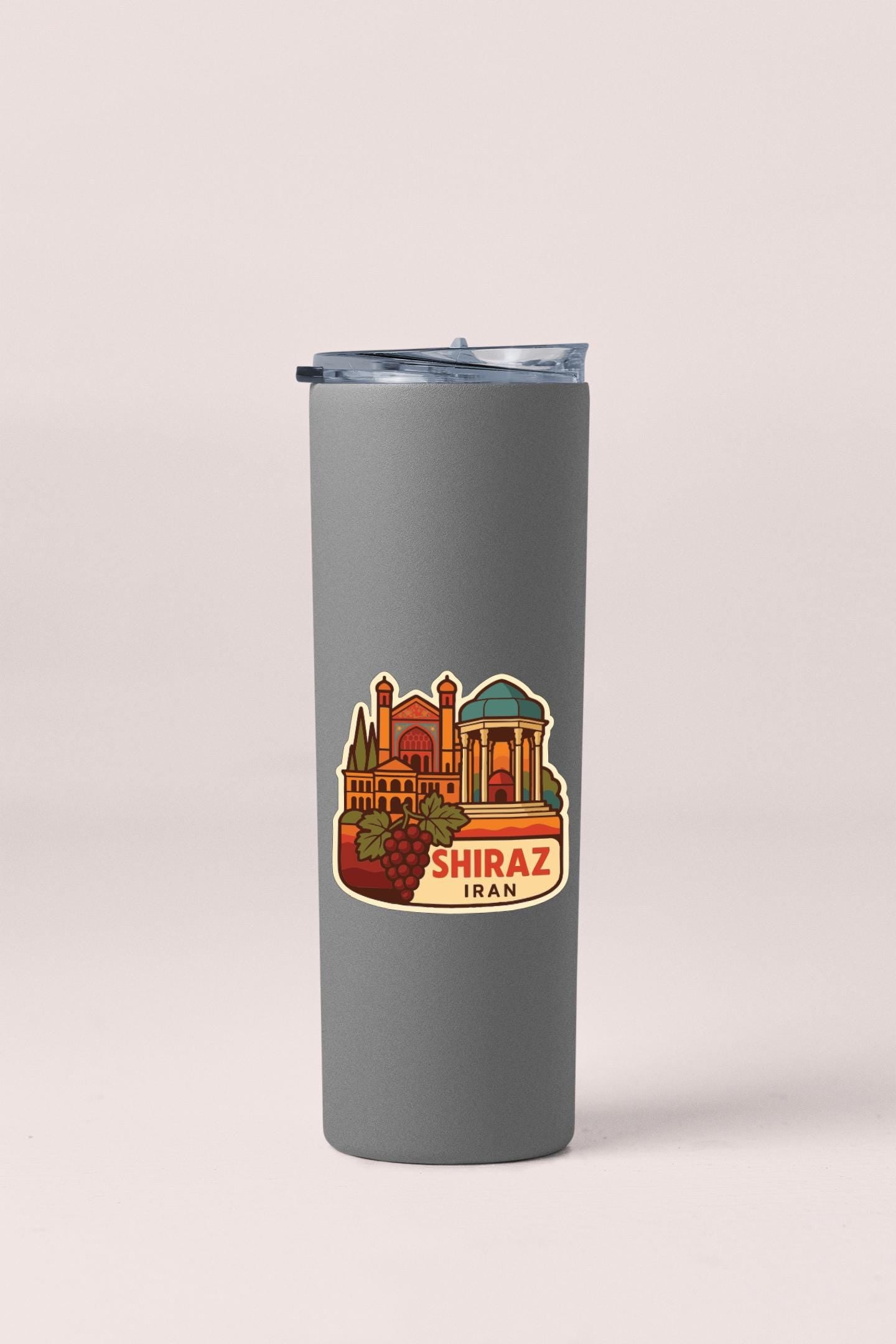 A gray insulated tumbler with a sticker depicting a cityscape and the text "SHIRAZ IRAN" printed on it.