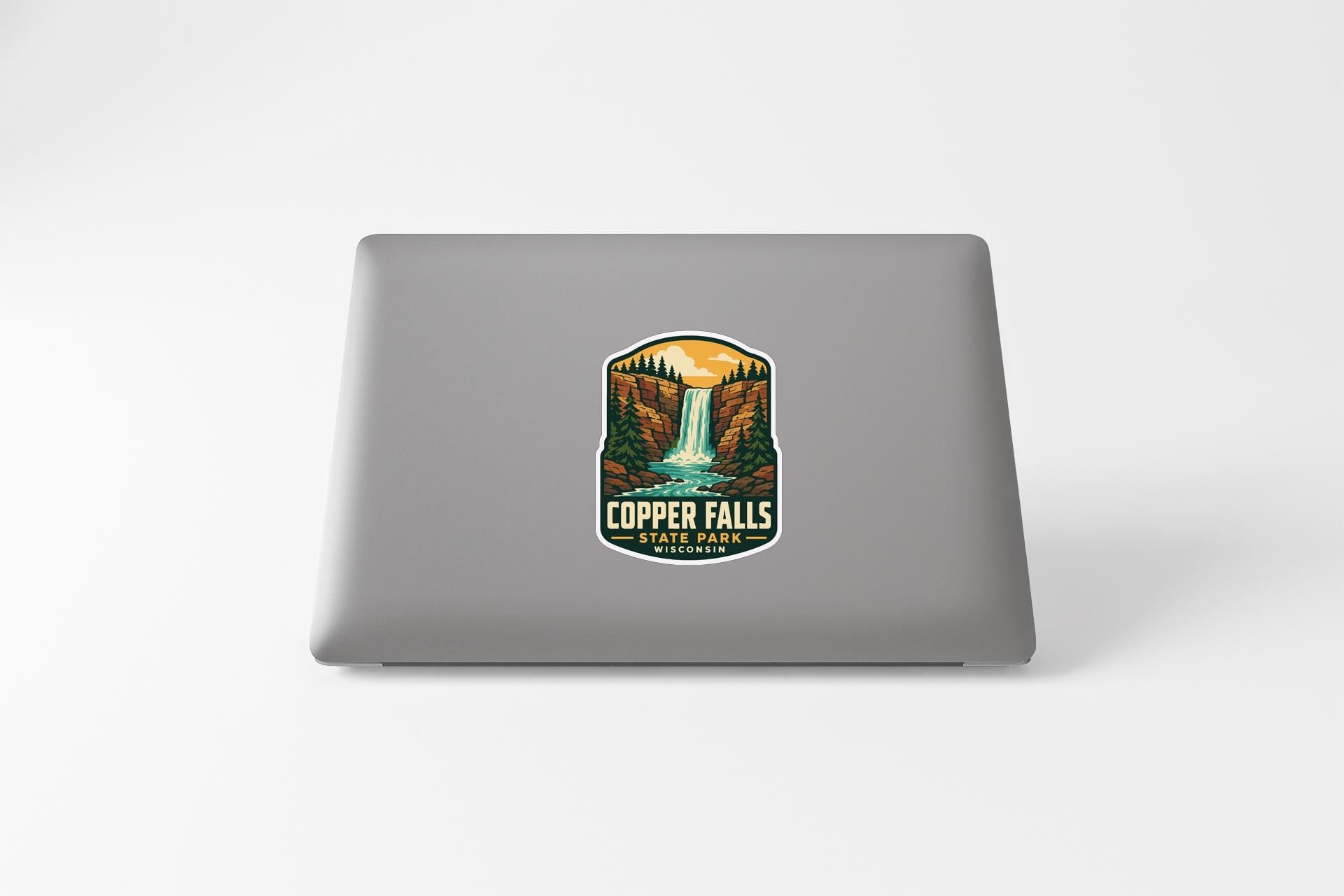 A sticker featuring a scenic landscape with a waterfall and mountains, representing Copper Falls State Park.