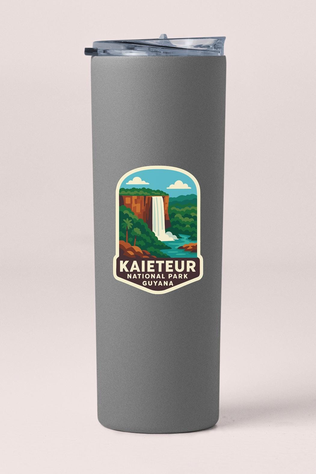 A gray cylindrical container with a lid and a label that says "Kaieteur National Park, Guyana".