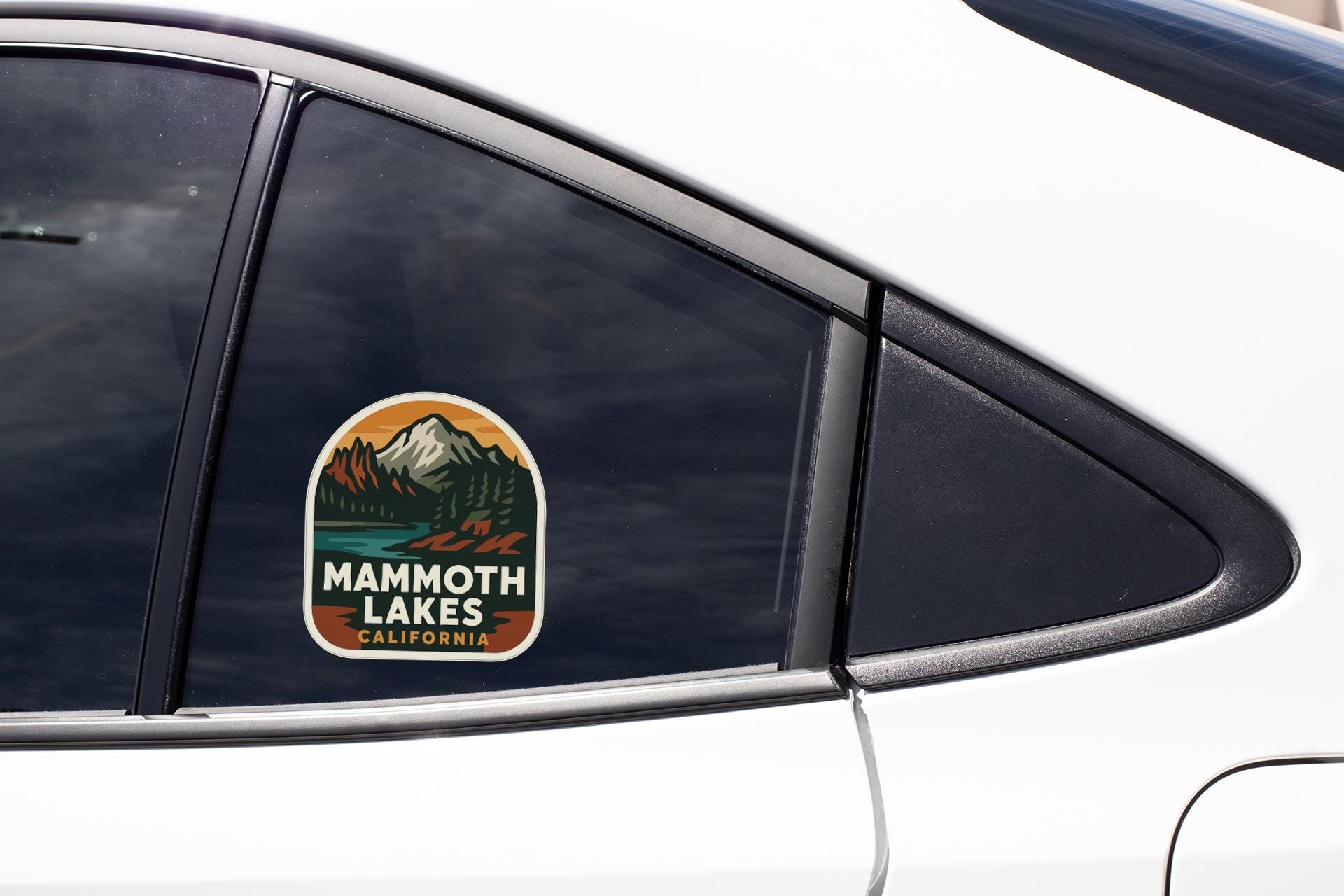 A car window with a sticker that says "Mammoth Lakes, California".