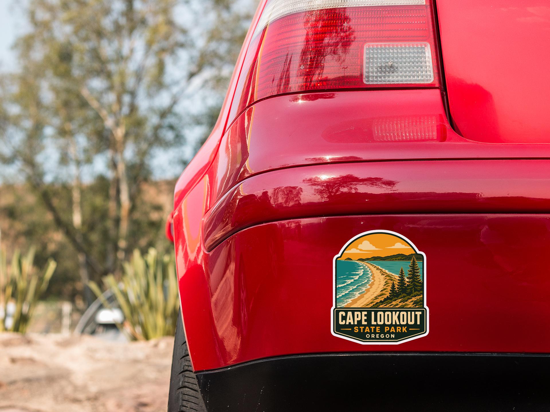 the rear end of a red car with a Cape Lookout State Park sticker on the trunk.