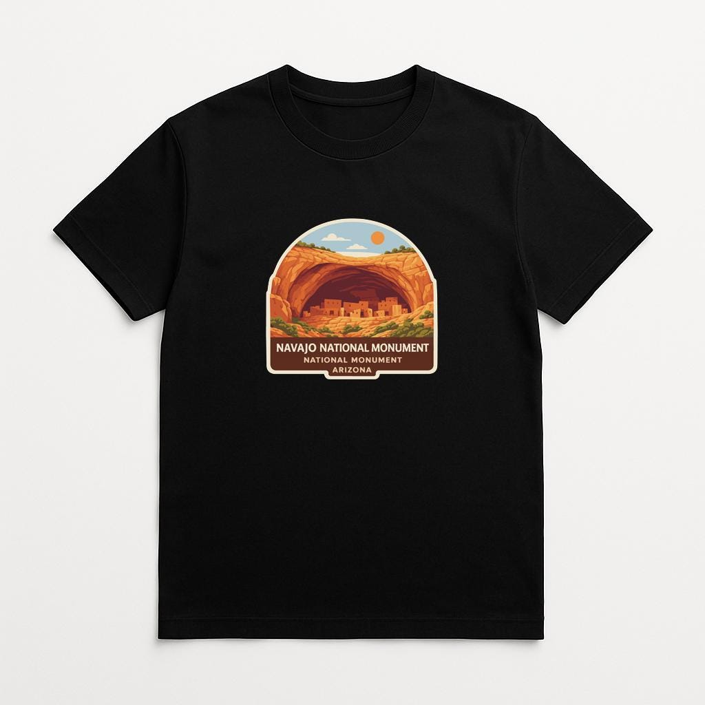 A black t-shirt with a graphic design depicting the Navajo National Monument in Arizona.