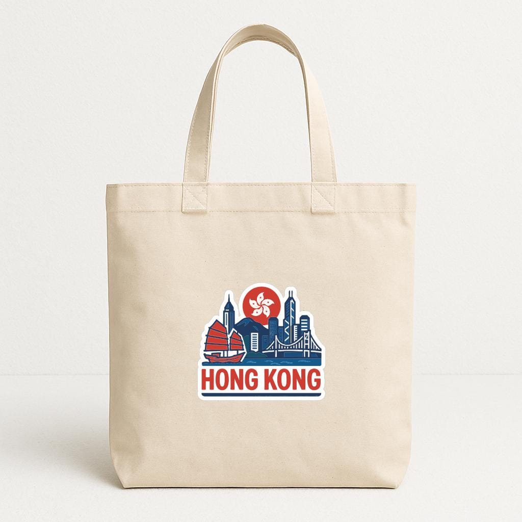 A beige tote bag with a graphic design featuring the Hong Kong skyline and the text "HONG KONG" printed on it.