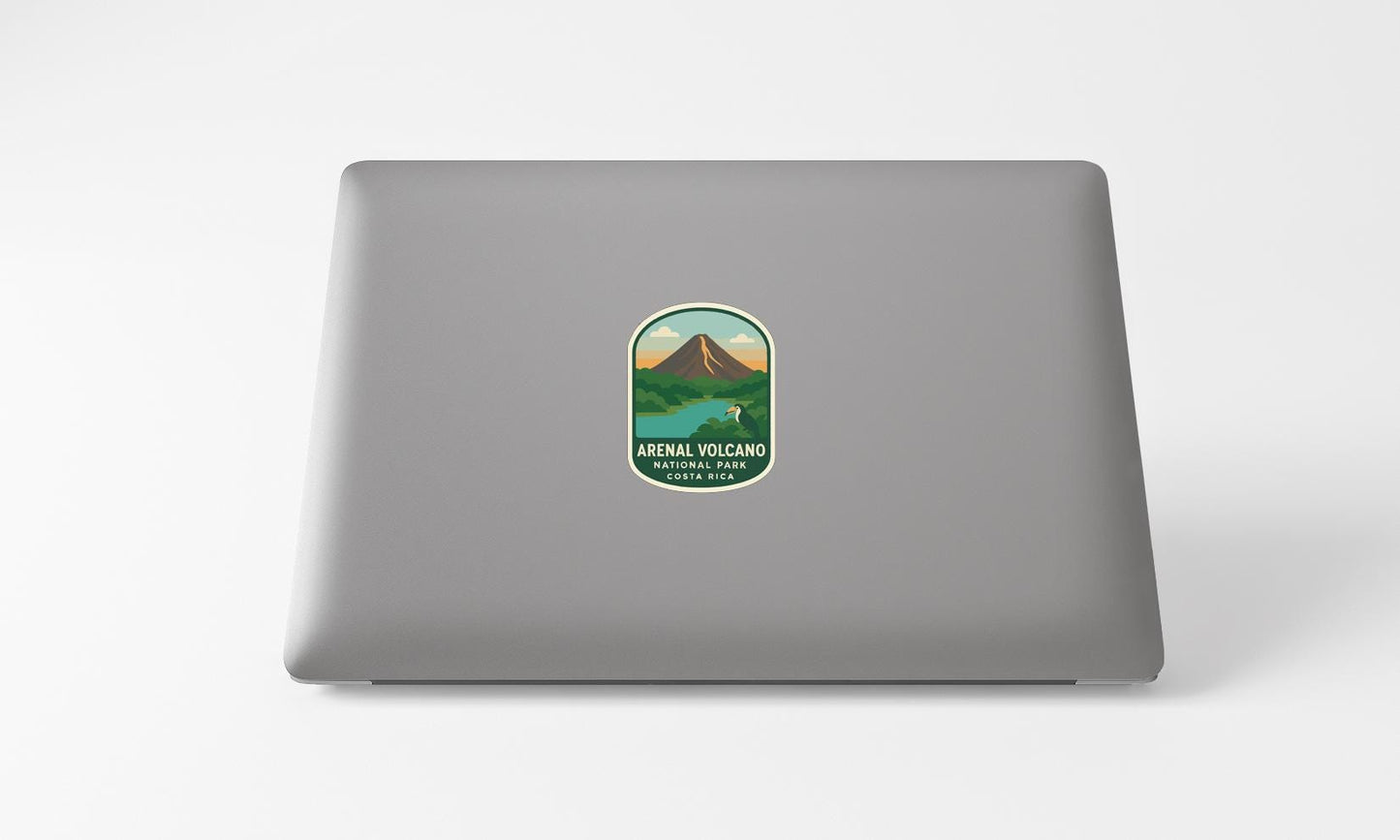 a sticker with a mountain and a lake on a laptop.