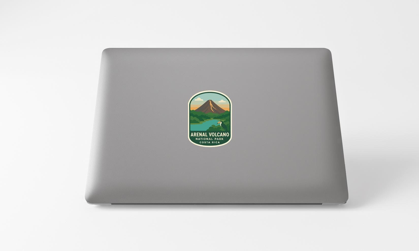 a sticker with a mountain and a lake on a laptop.