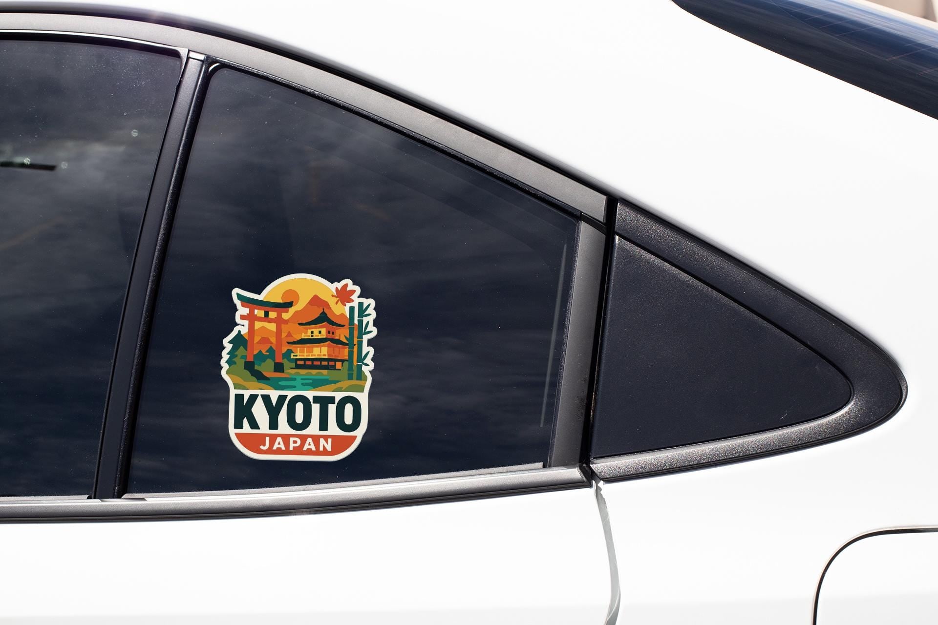 A sticker on the side of a car window, depicting a temple and the word "KYOTO" in bold letters.
