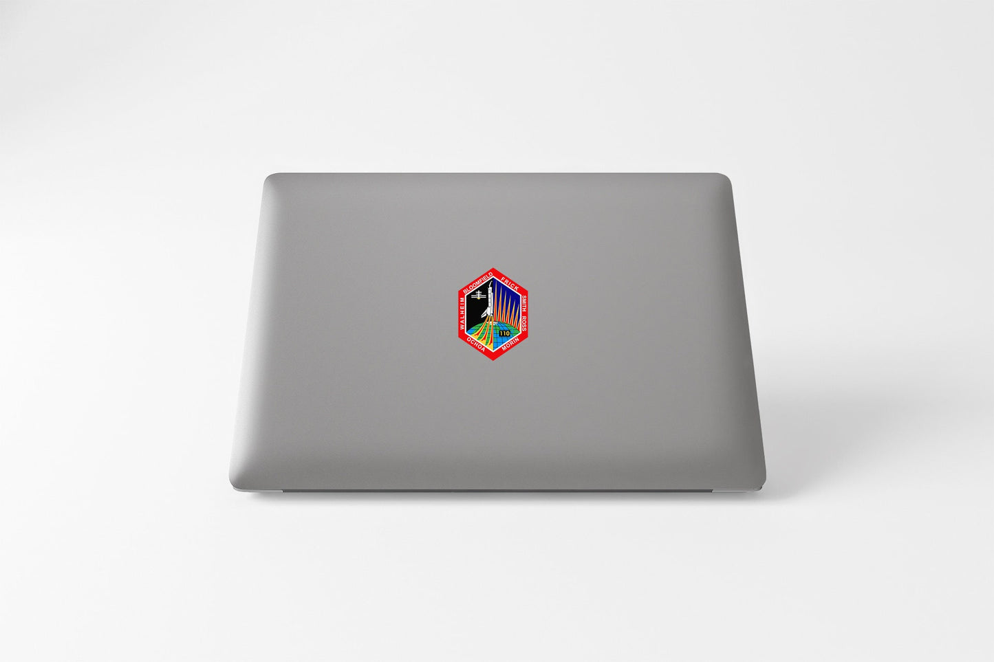 a laptop computer with a colorful sticker on it