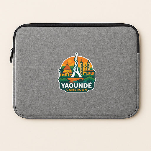 a gray laptop sleeve with a graphic design of a city skyline and the text "YAOUDE CAMERON" printed on it.