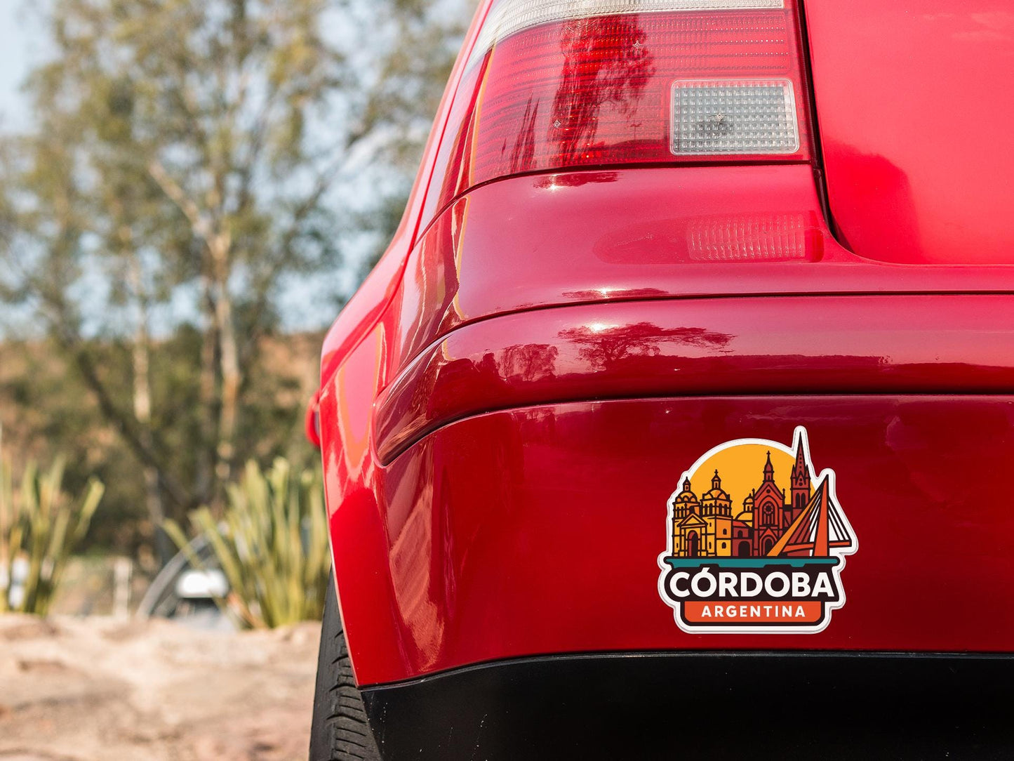 the rear end of a red car with a sticker on the trunk that says "CORDOBA ARGENTINA".