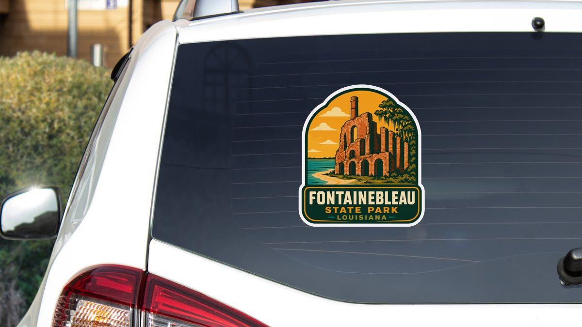 a sticker on the rear window of a white car, depicting a landmark called Fontainebleau State Park in Louisiana.