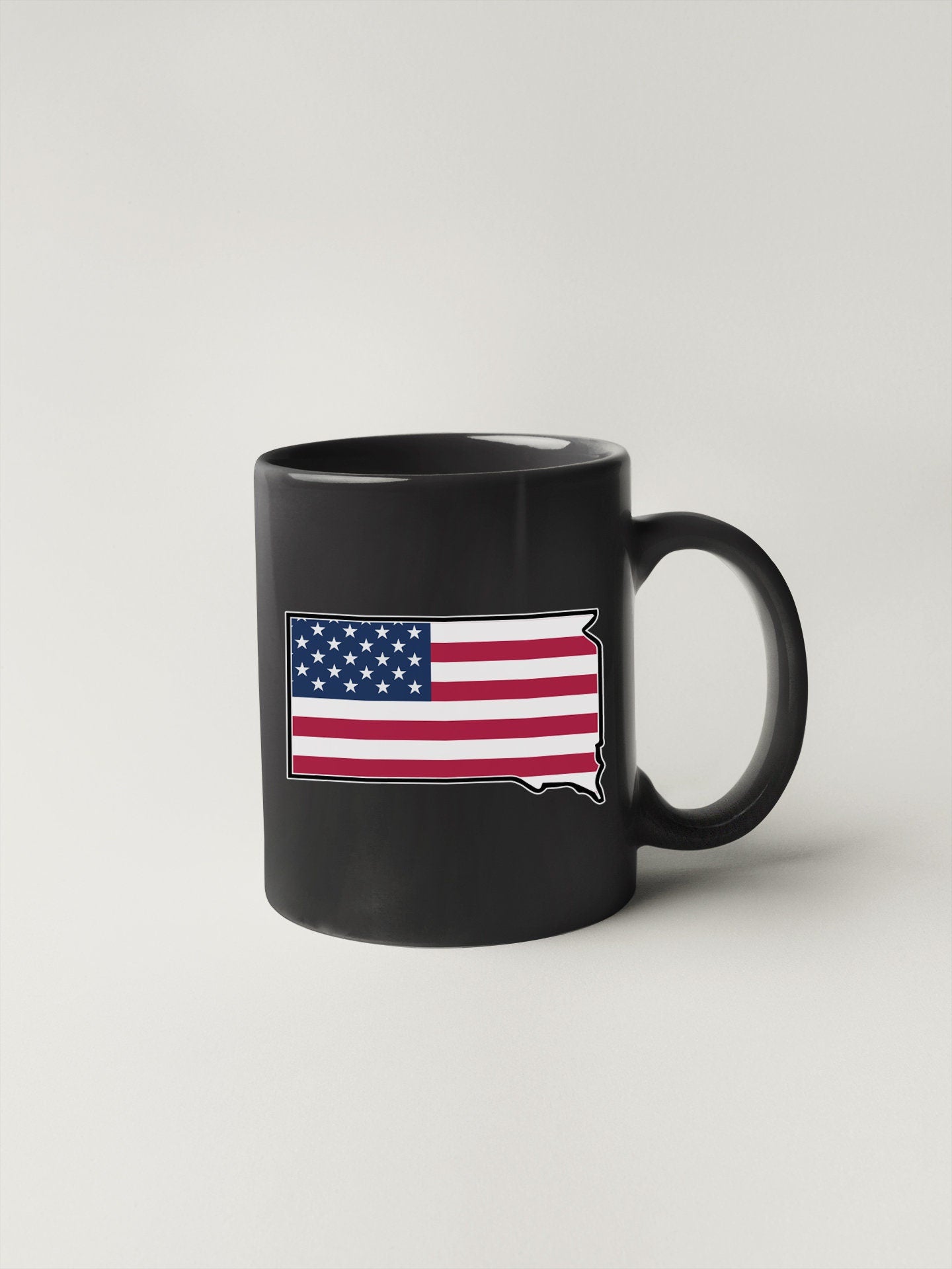 a black coffee mug with the american flag on it