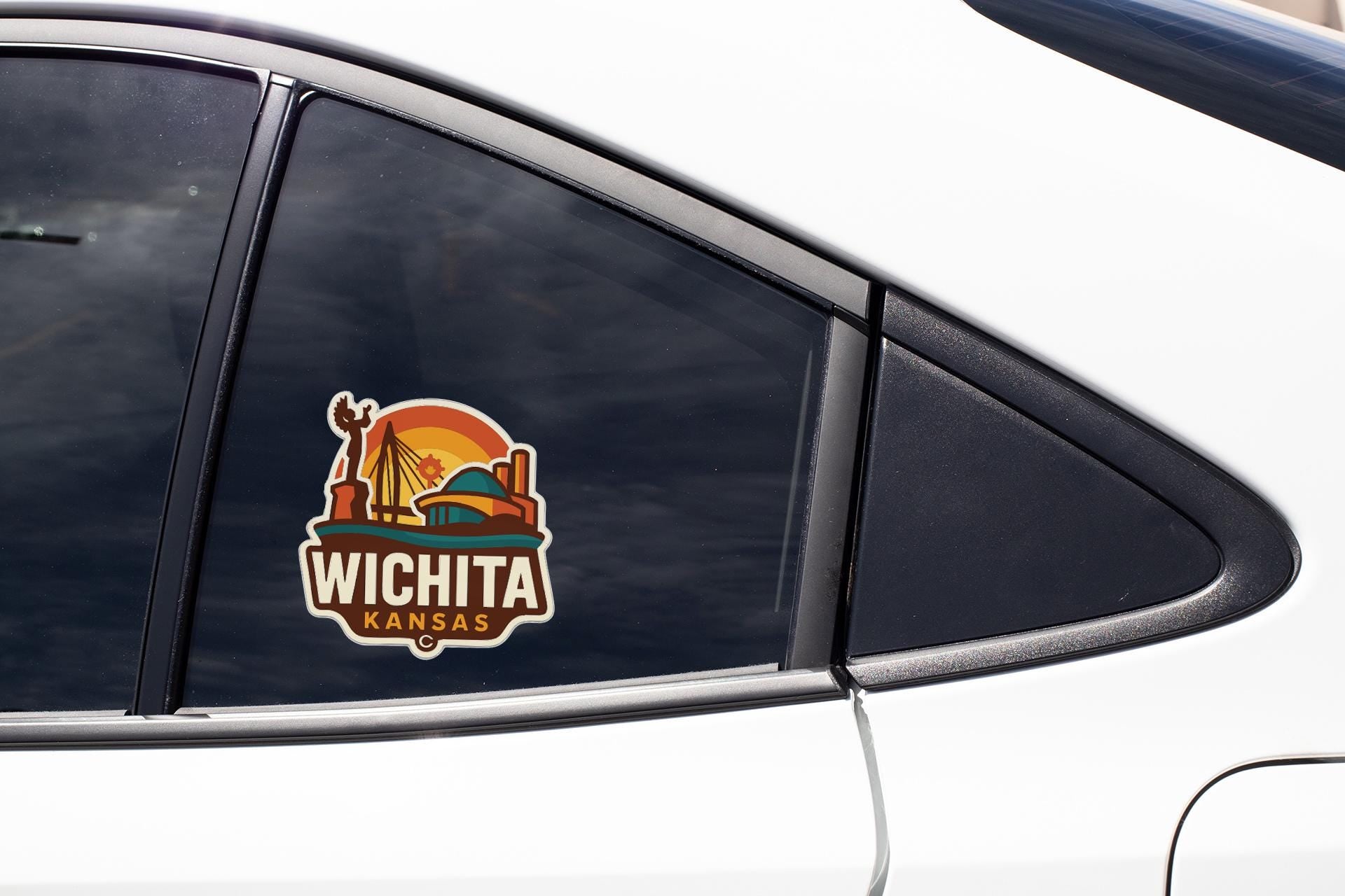 A sticker on the side of a car window that says "Wichita Kansas".
