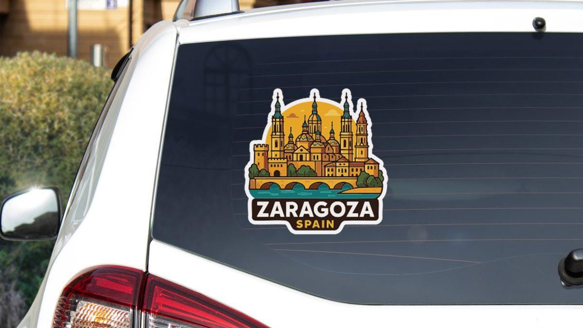 A sticker on the rear window of a car that features a stylized illustration of a city skyline with a bridge, along with the text "ZARAGOZA, SPAIN".