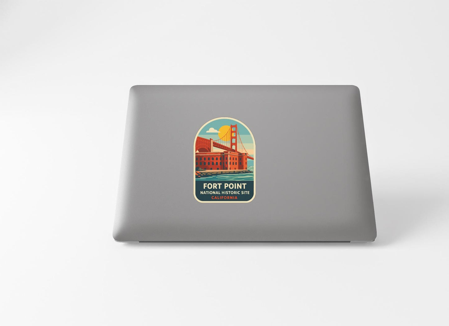 a sticker on the back of a laptop that displays a graphic of the Golden Gate Bridge and the text "Fort Point National Historic Site".