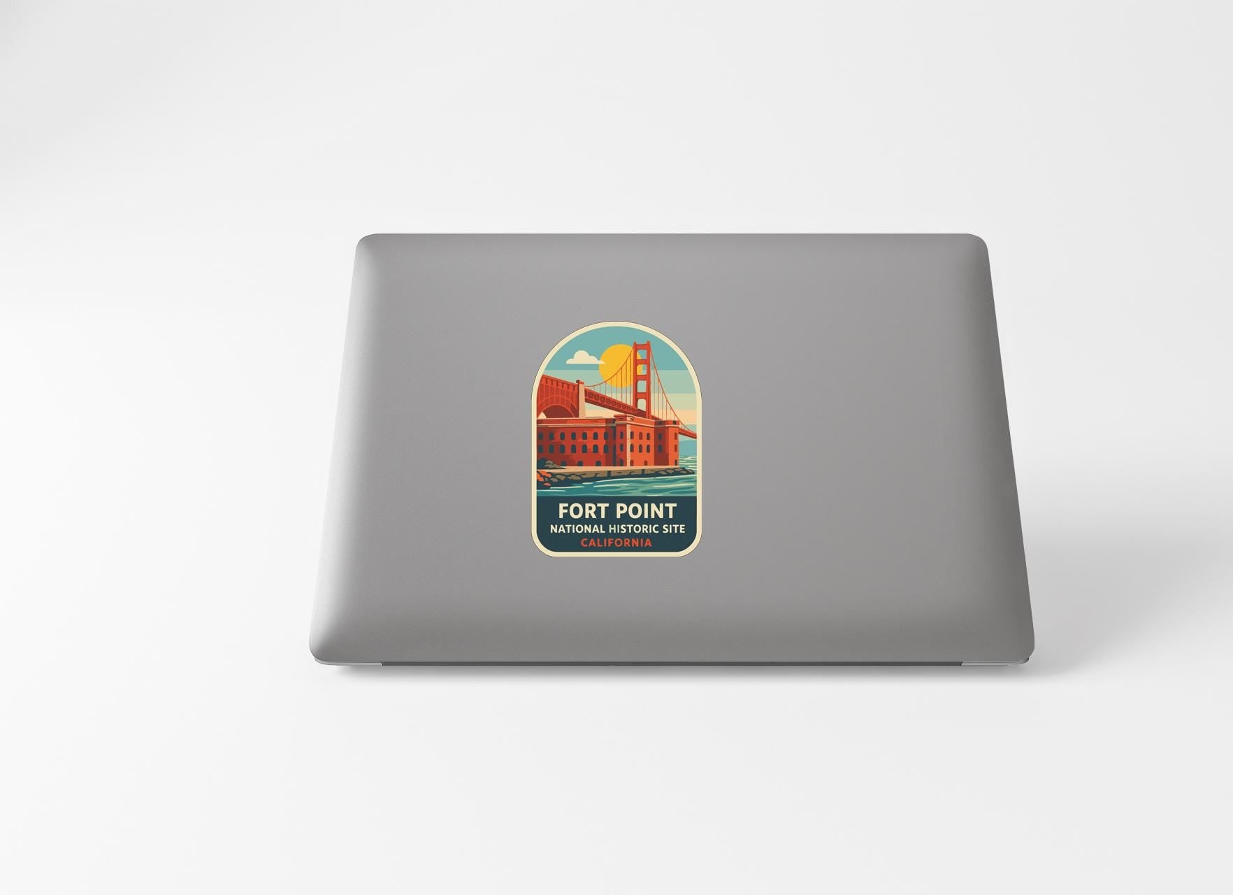 a sticker on the back of a laptop that displays a graphic of the Golden Gate Bridge and the text "Fort Point National Historic Site".