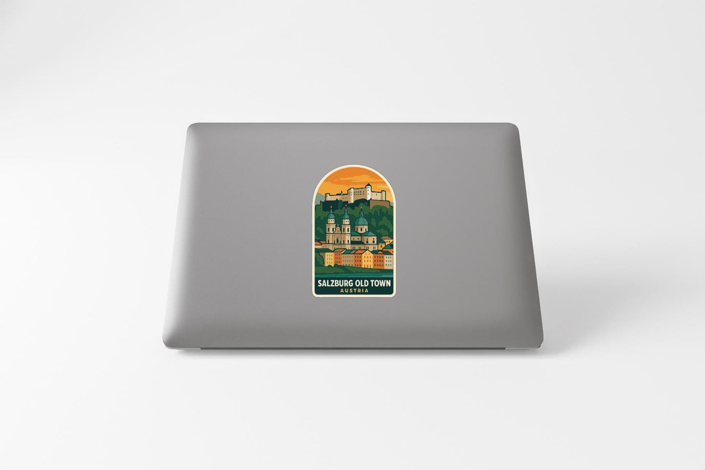 a sticker or decal of Salzburg Old Town on the back of a laptop computer.