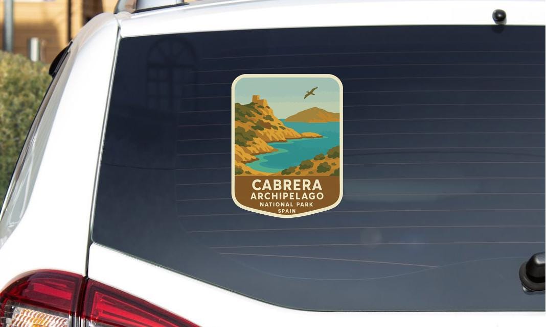 a sticker on the rear window of a car, depicting a scenic landscape with mountains, a lake, and a bird in flight.