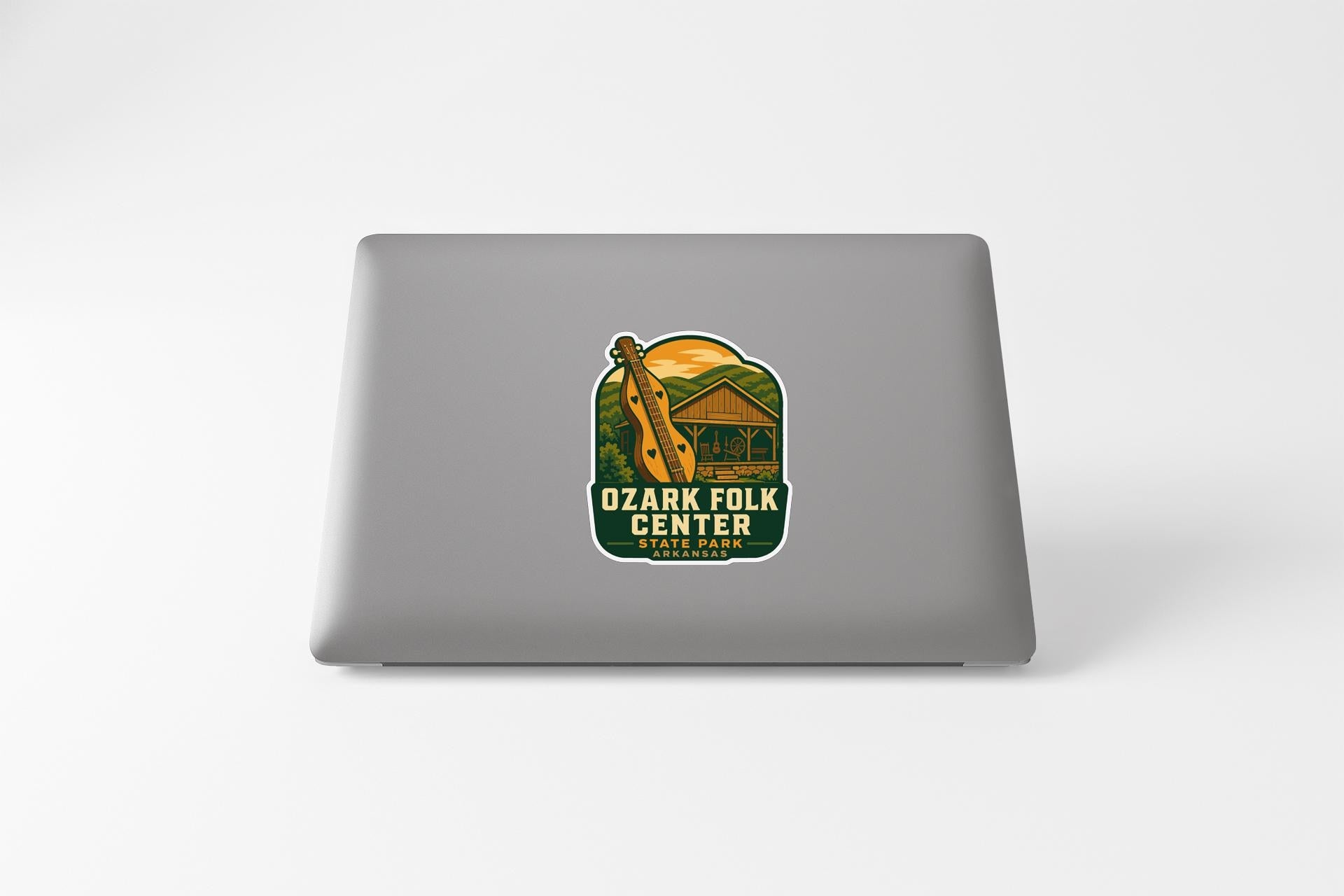 a sticker on a laptop that displays the logo for the Ozark Folk Center in Arkansas.