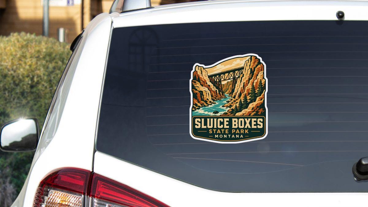 A sticker on the rear window of a white vehicle, depicting a scenic landscape with a bridge and a river.
