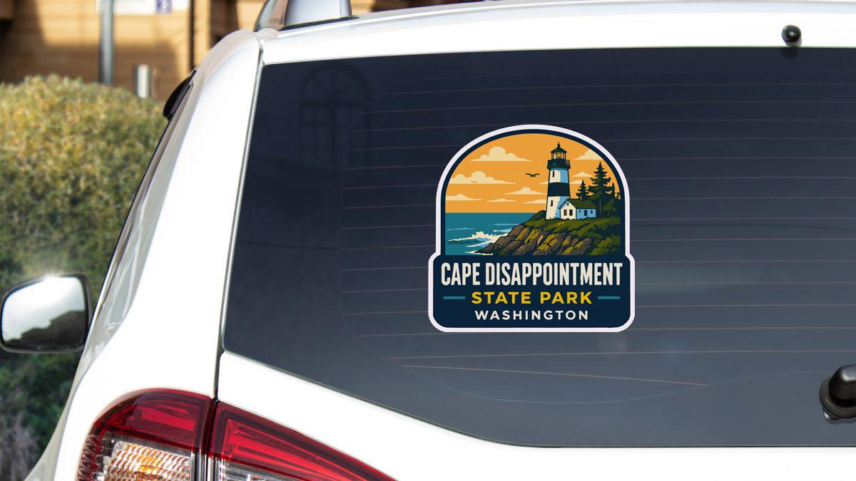 a sticker on the rear window of a vehicle that says "Cape Disappointment State Park Washington".