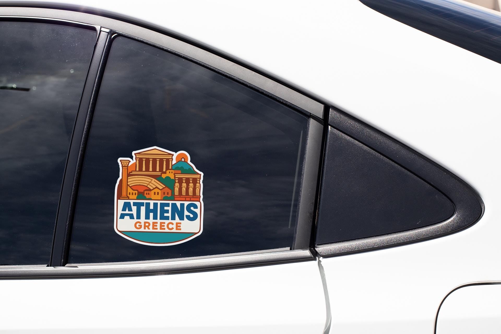 A sticker on the side of a car window that says "Athens Greece".